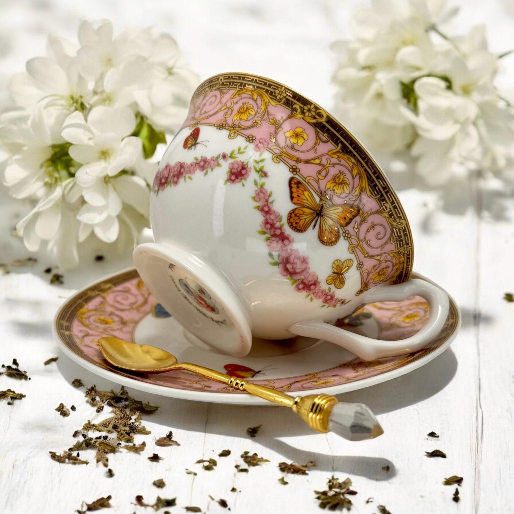 Luxury gold-accented teacup with permanent symbols inside, perfect for tea leaf reading and divination, curated by Karin in her home studio