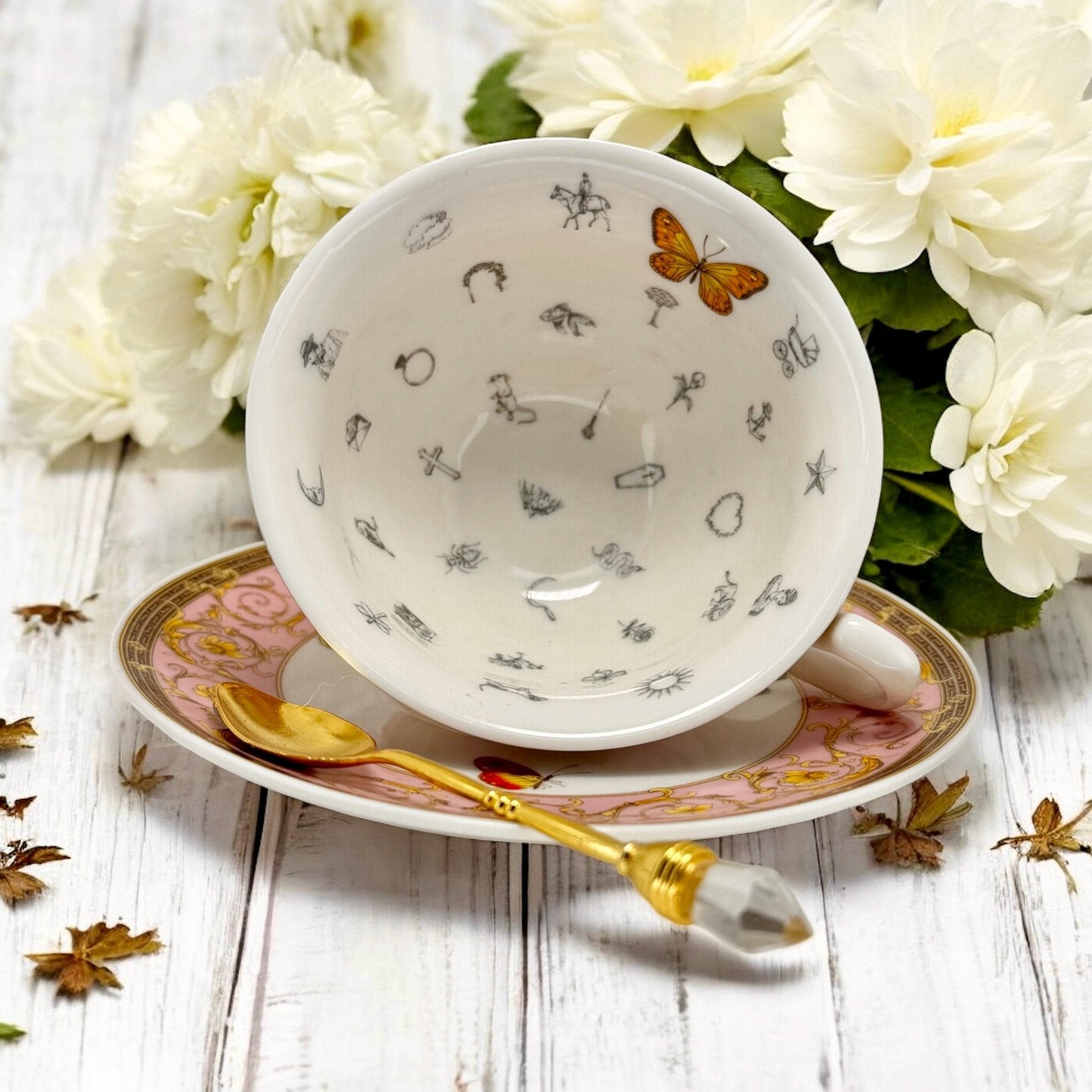 Luxury gold-accented teacup with permanent symbols inside, perfect for tea leaf reading and divination, curated by Karin in her home studio