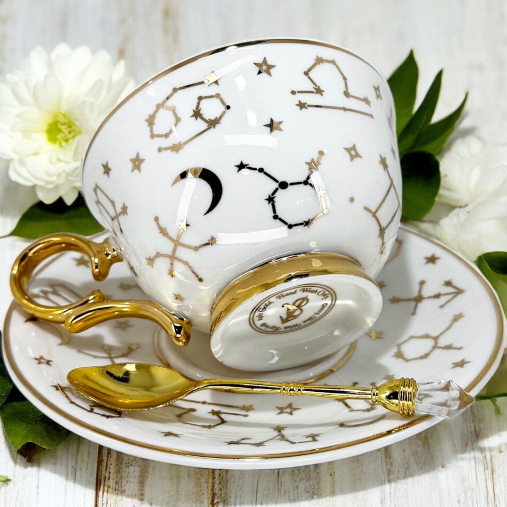 Luxury gold-accented teacup with permanent Tasseography symbols inside, including astrology symbols and a gold verse, perfect for tea leaf reading and divination.