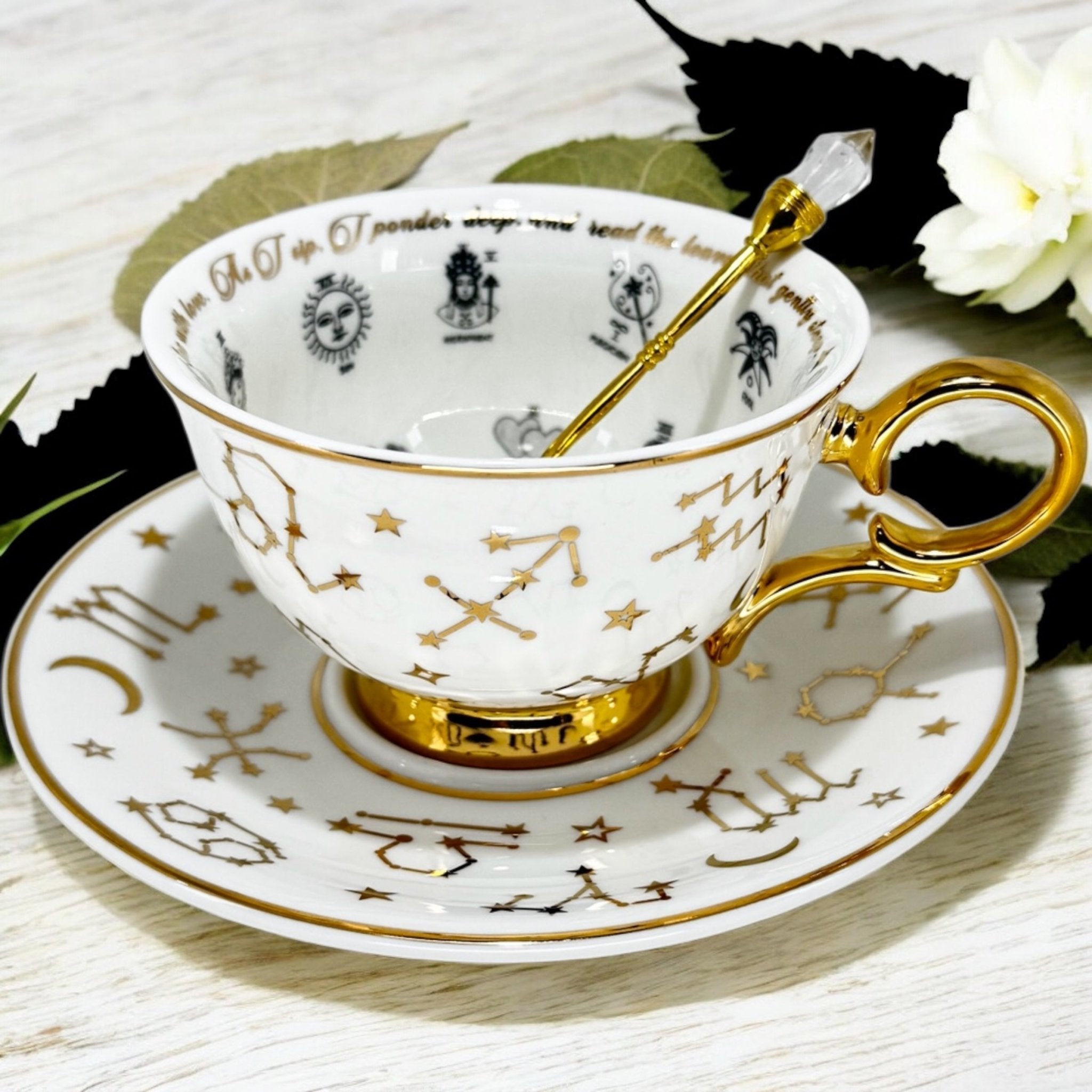 Luxury gold-accented teacup with permanent symbols inside, perfect for tea leaf reading and divination, curated by Karin in her home studio