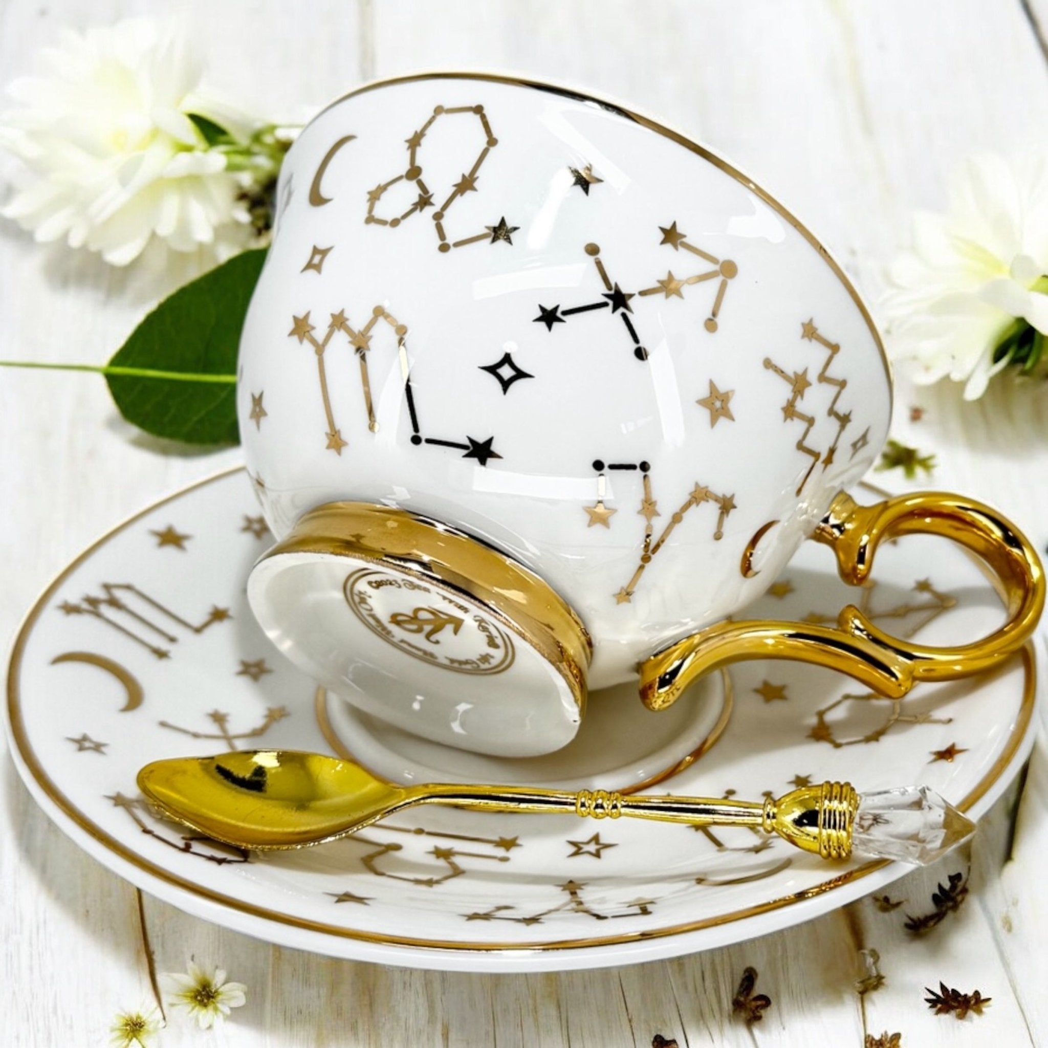 Luxury gold-accented teacup with permanent Tasseography symbols inside, including astrology symbols and a gold verse, perfect for tea leaf reading and divination.