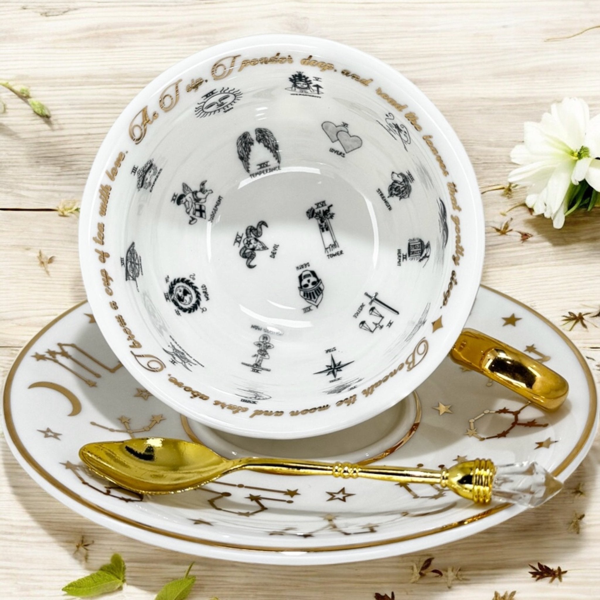 Luxury gold-accented teacup with permanent symbols inside, perfect for tea leaf reading and divination, curated by Karin in her home studio