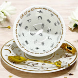 Luxury gold-accented teacup with permanent Tasseography symbols inside, including astrology symbols and a gold verse, perfect for tea leaf reading and divination.