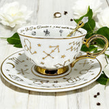 Luxury gold-accented teacup with permanent Tasseography symbols inside, including astrology symbols and a gold verse, perfect for tea leaf reading and divination.