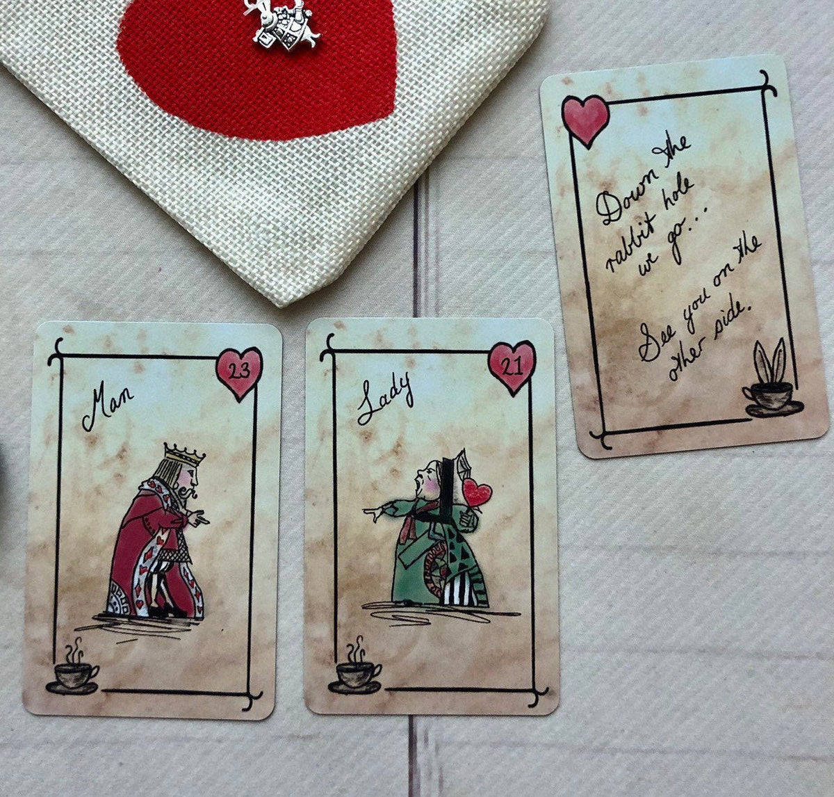 Alice in Wonderland oracle cards fanned out showing vibrant illustrated card backs