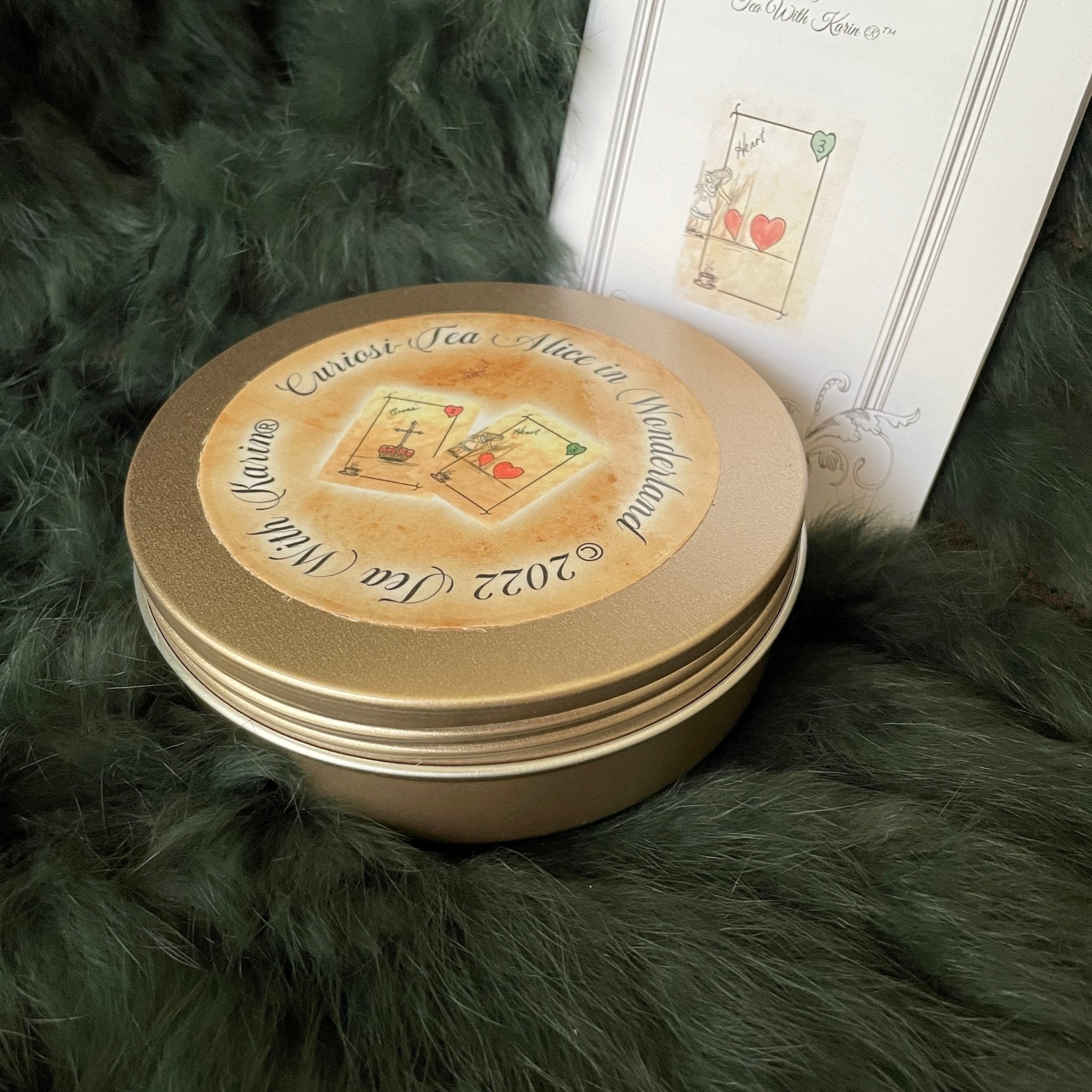 This is a unique divination system all in one tinned kit.  It is based upon tea leaf reading and Alice in Wonderland theme. It has a washable spandex mat and 18 mini cards and 18 charms and 3 dice.