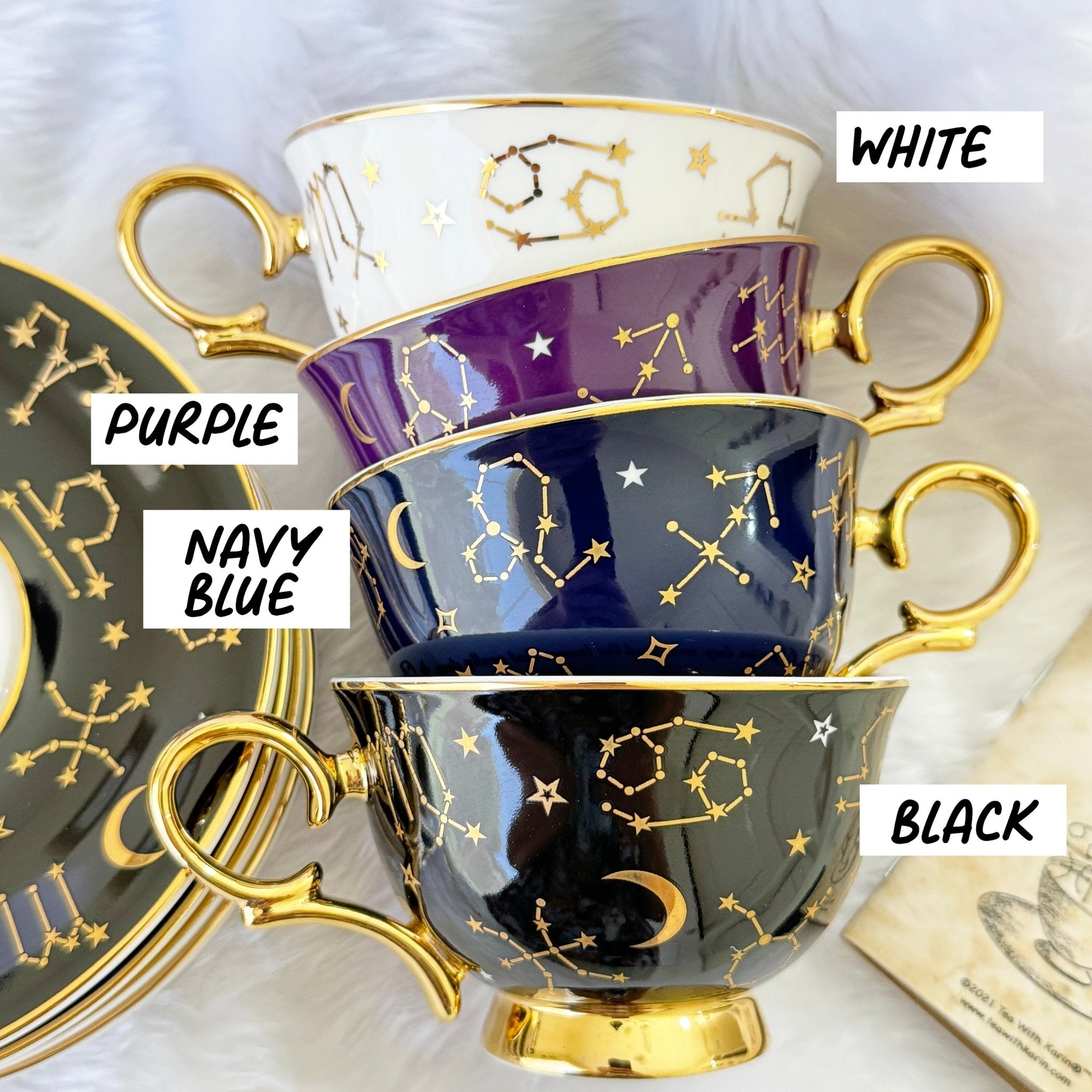 Black tarot-themed teacup and saucer set with mystical tarot symbols inside, accompanied by a symbol guidebook and a gold teaspoon, ideal for daily tea leaf reading and divination