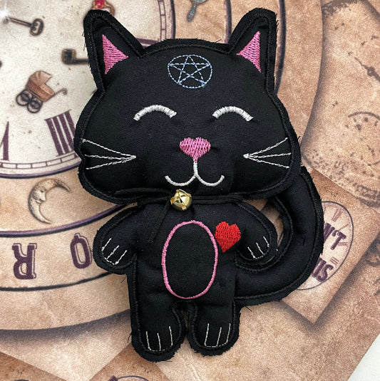 Lucky Black Cat spirit doll. This doll has 12 unique charms that you use to create your spells and then wrap the charm in the paper that you have written your wishes on and then put in his back pack and ring the bell to call in spirit.