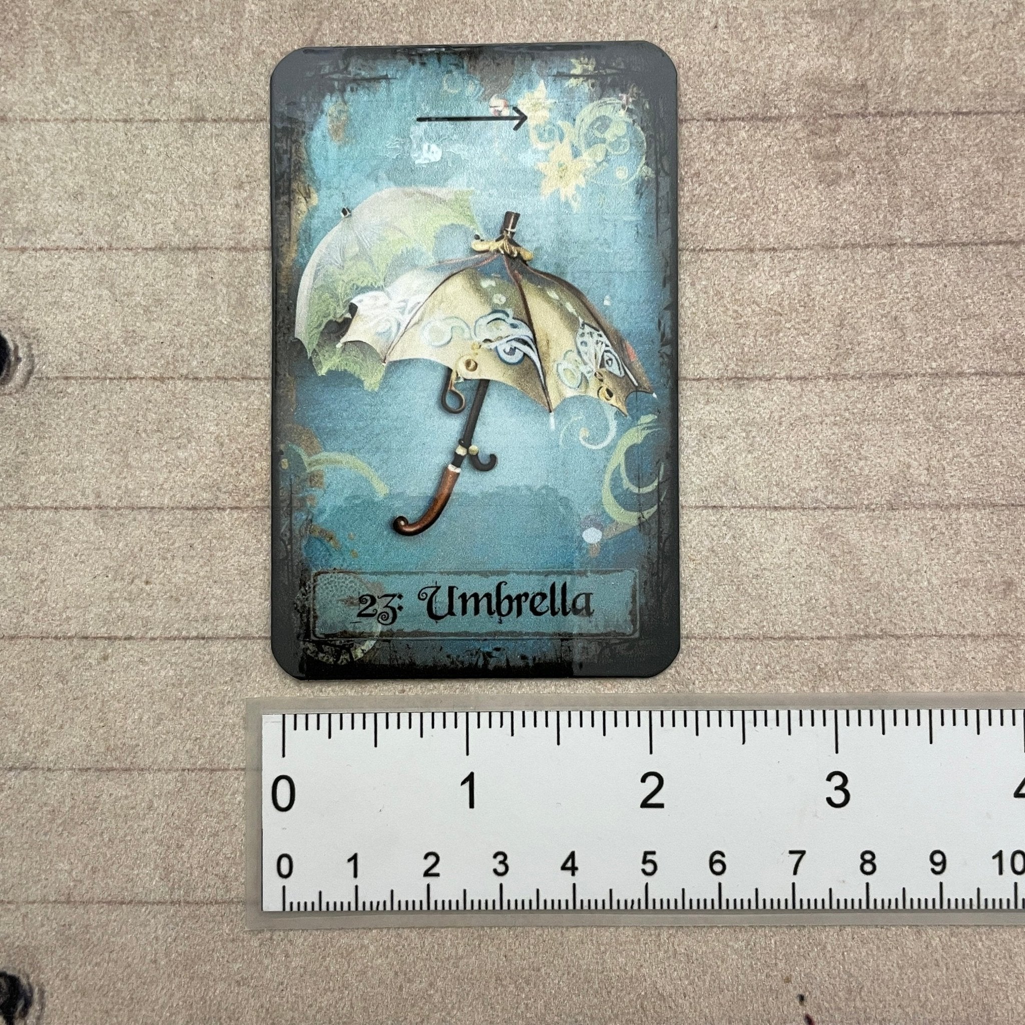 Tea leaf reading card deck with 45 high-gloss, 300gsm cards featuring unique symbols, a symbol dictionary, and a gold teaspoon, presented in a cotton drawstring bag