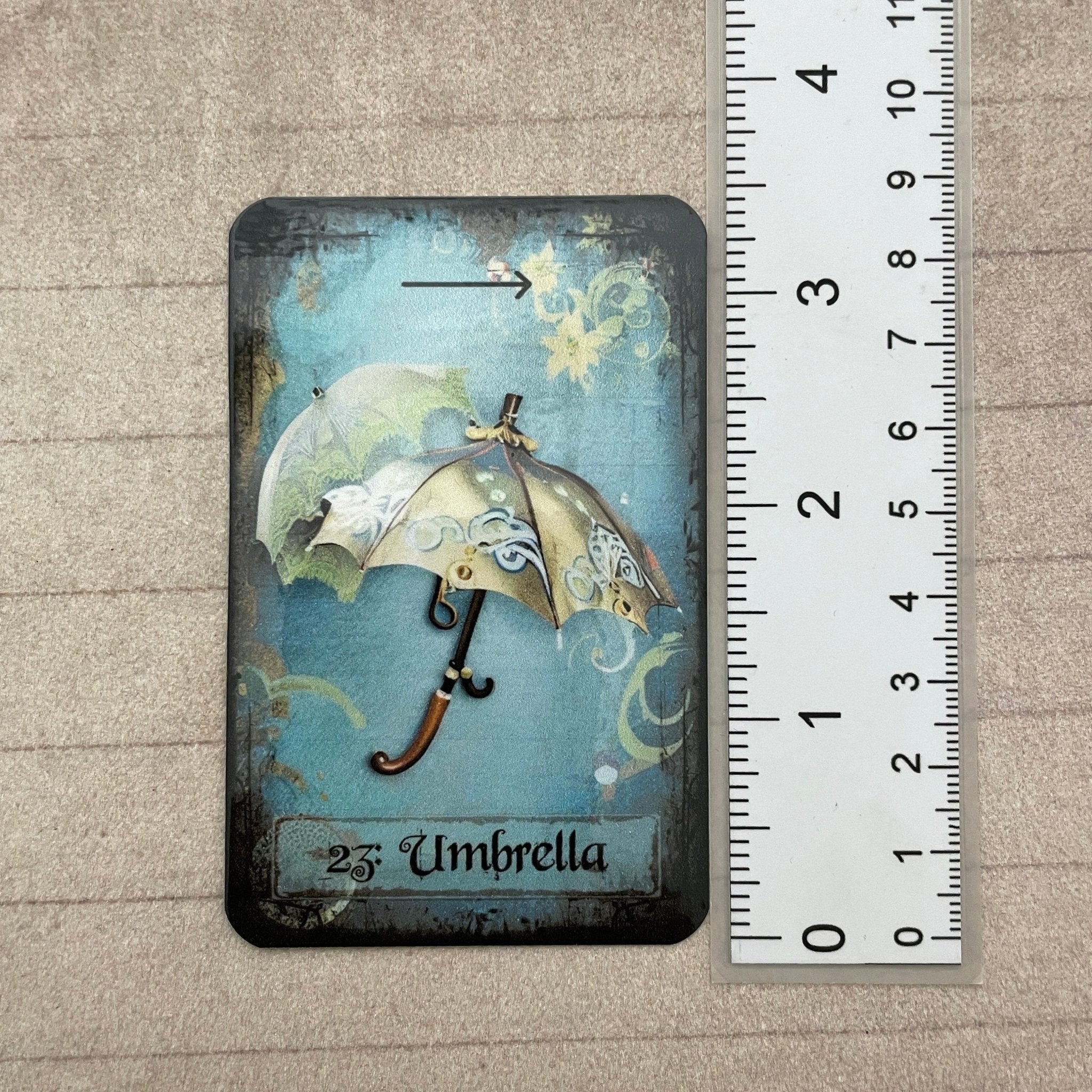 Tea leaf reading card deck with 45 high-gloss, 300gsm cards featuring unique symbols, a symbol dictionary, and a gold teaspoon, presented in a cotton drawstring bag