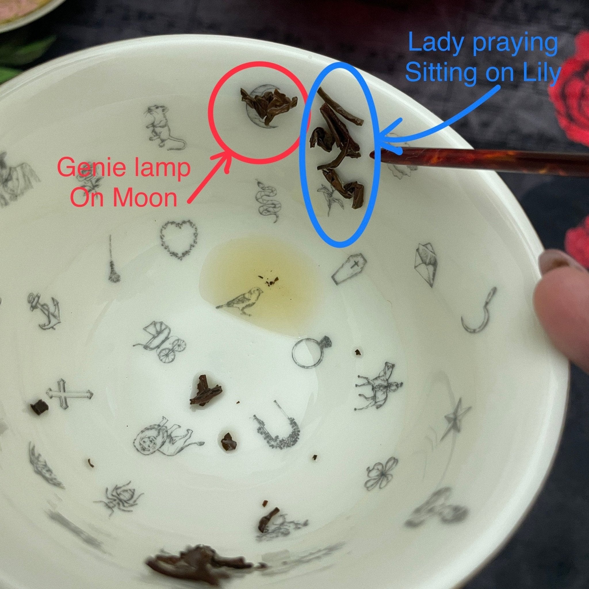 Witches Brew Tea Leaf Reading Teacup Set 227 – Interior of white fortune telling teacup showing tea leaves and gold witches brew reading symbols